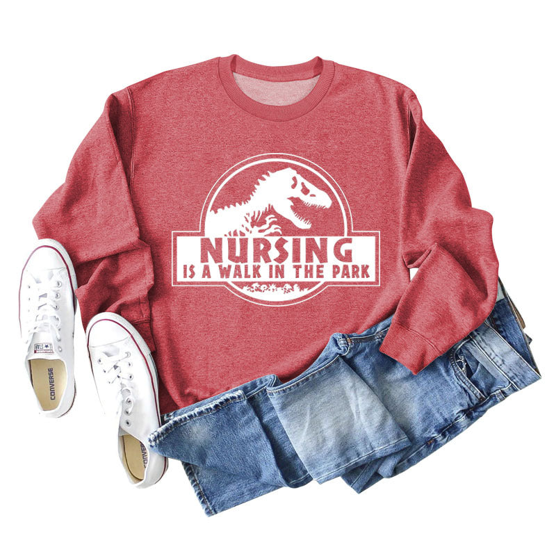 Nursing Is A Walk In The Park Langarm-Sweatshirt mit Rundhalsausschnitt, Dinosaurier-Print